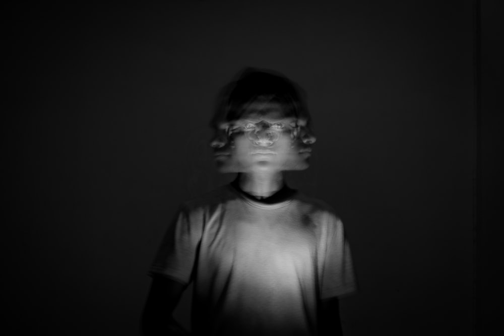 a blurry photo of a person in a dark room