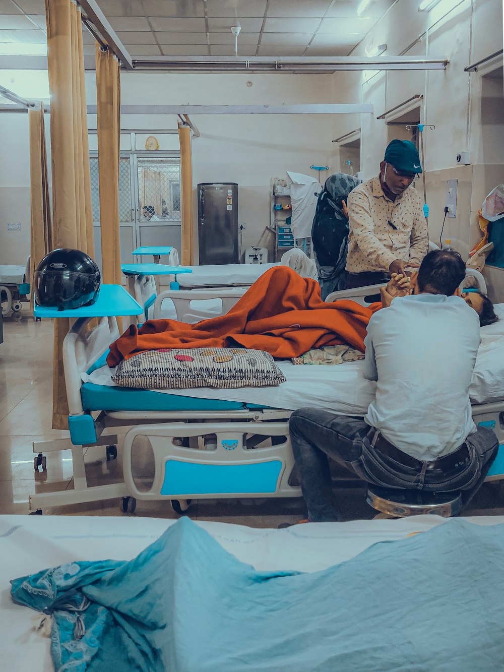 a group of people sitting around a hospital bed