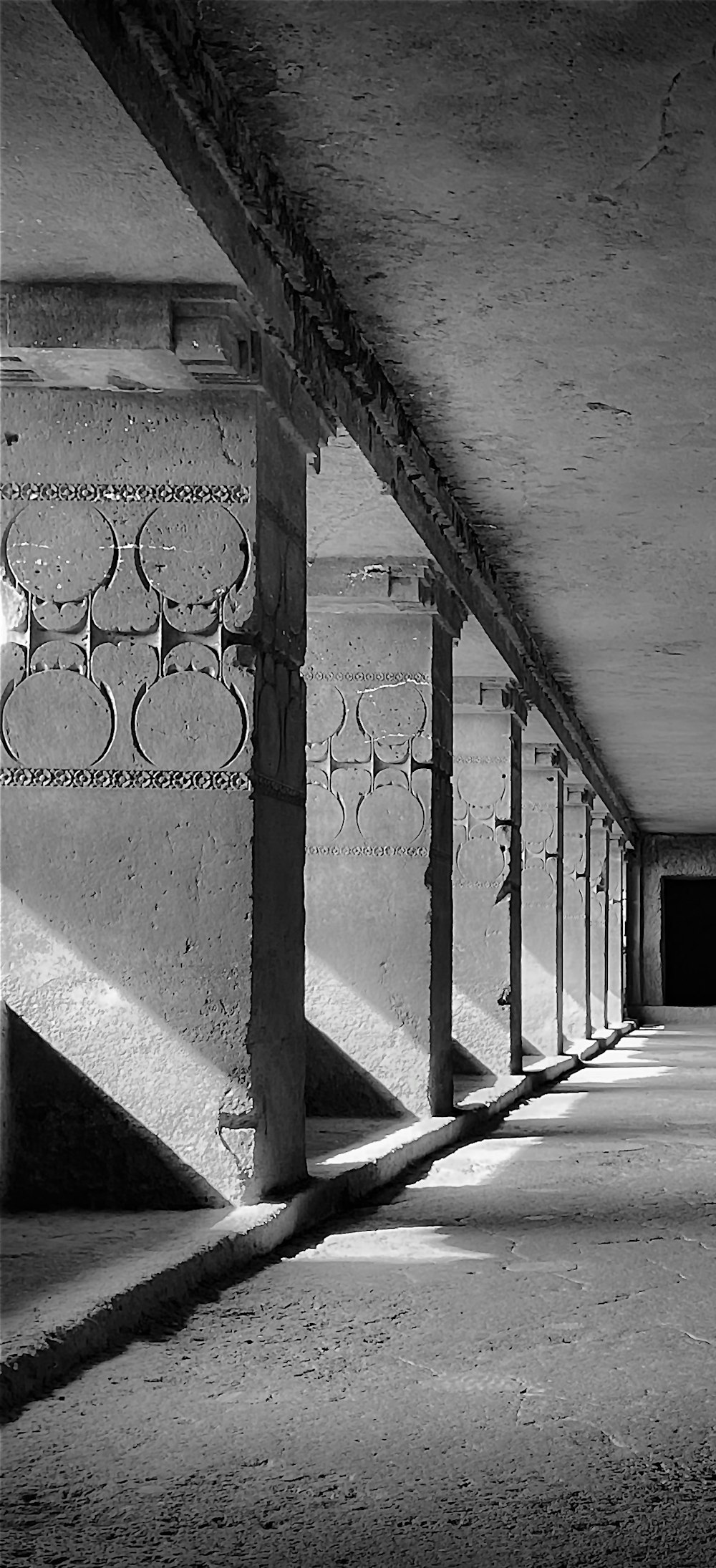 a black and white photo of a long hallway