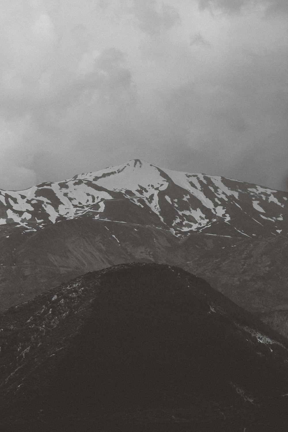 a black and white photo of a snow covered mountain