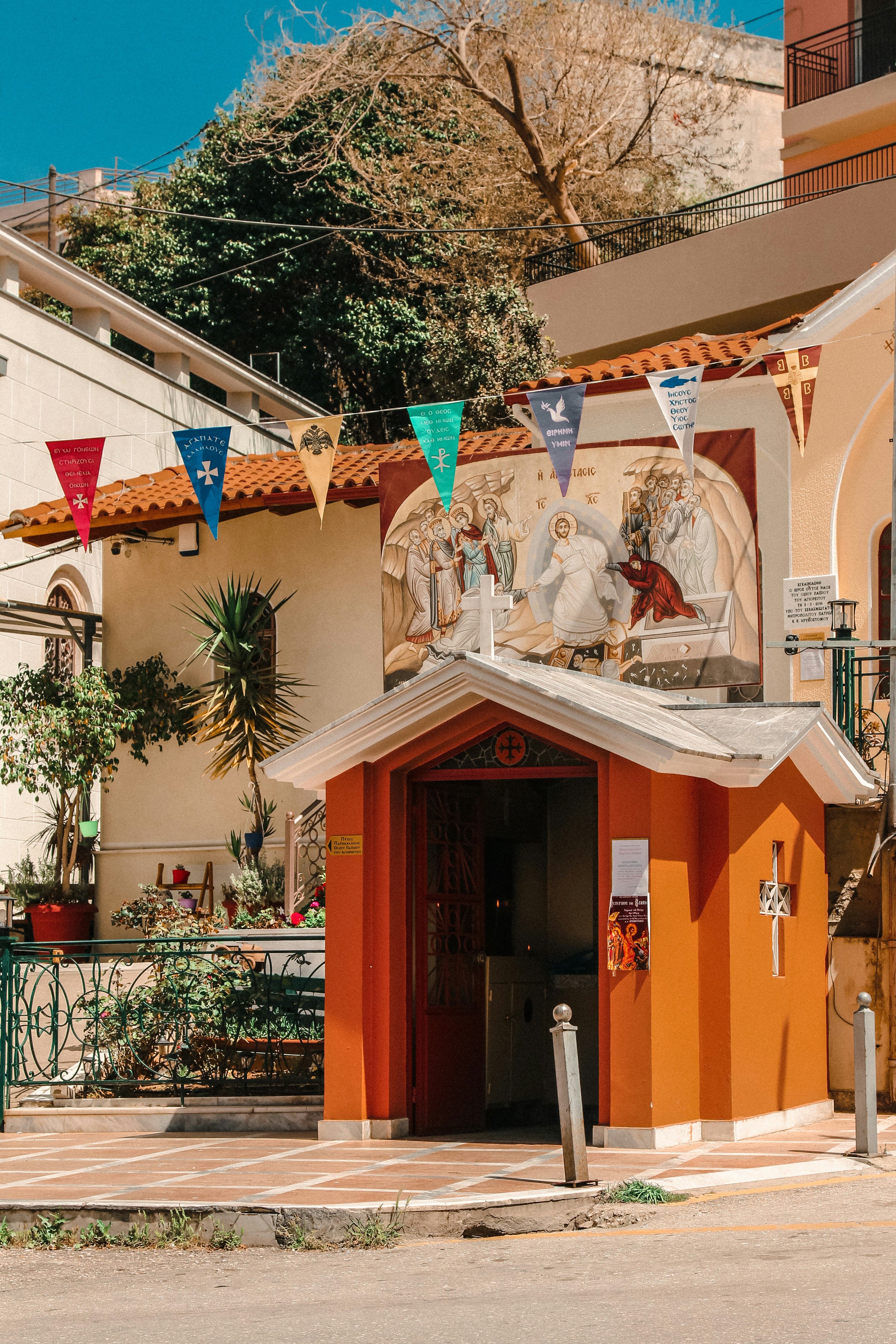 a small orange building with a painting on the side of it