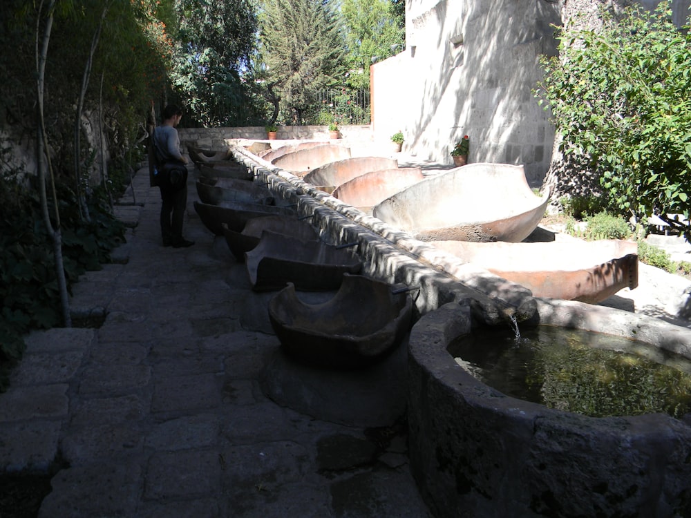 a row of boats sitting on top of a stone walkway