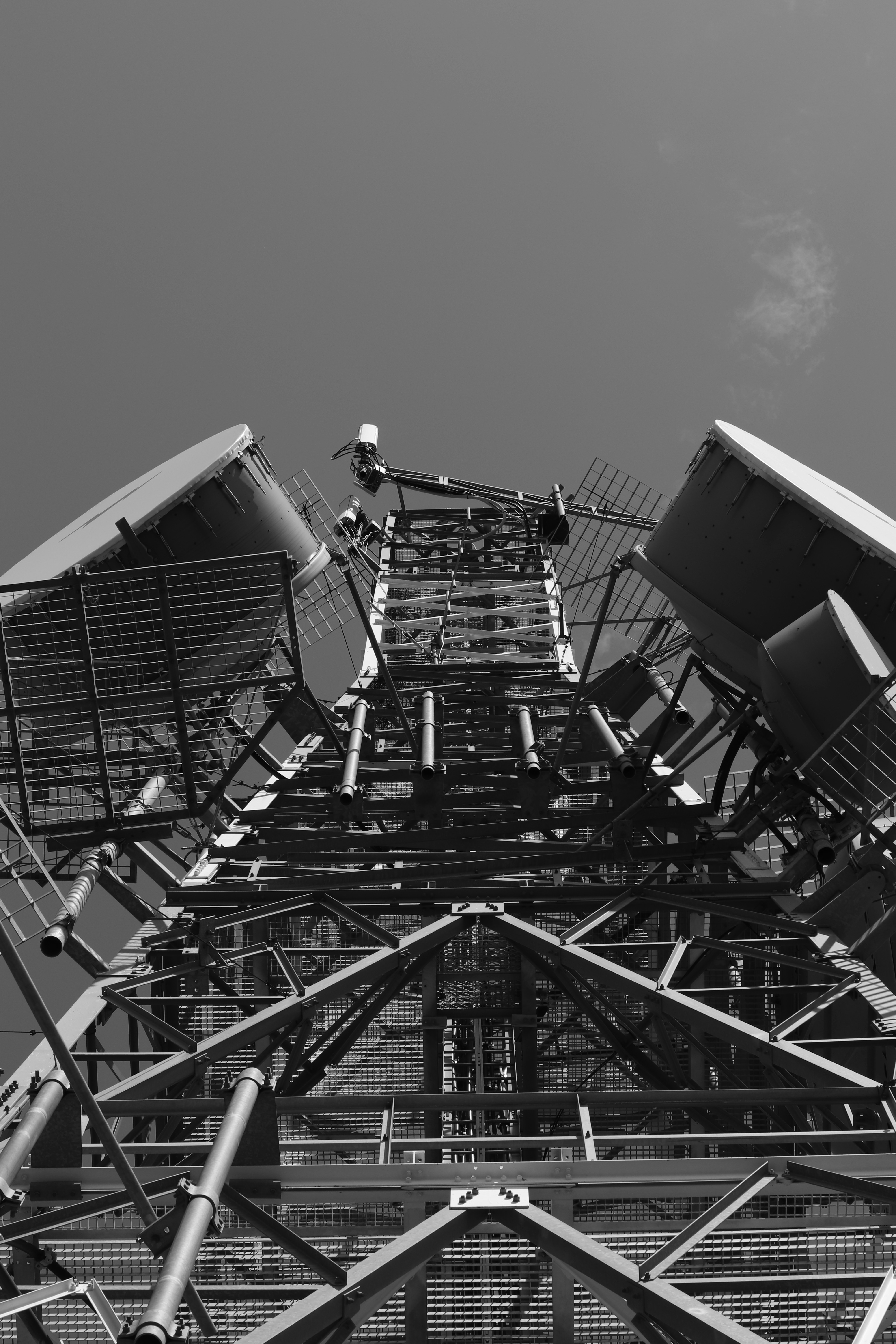 a very tall metal structure with lots of chairs on top of it