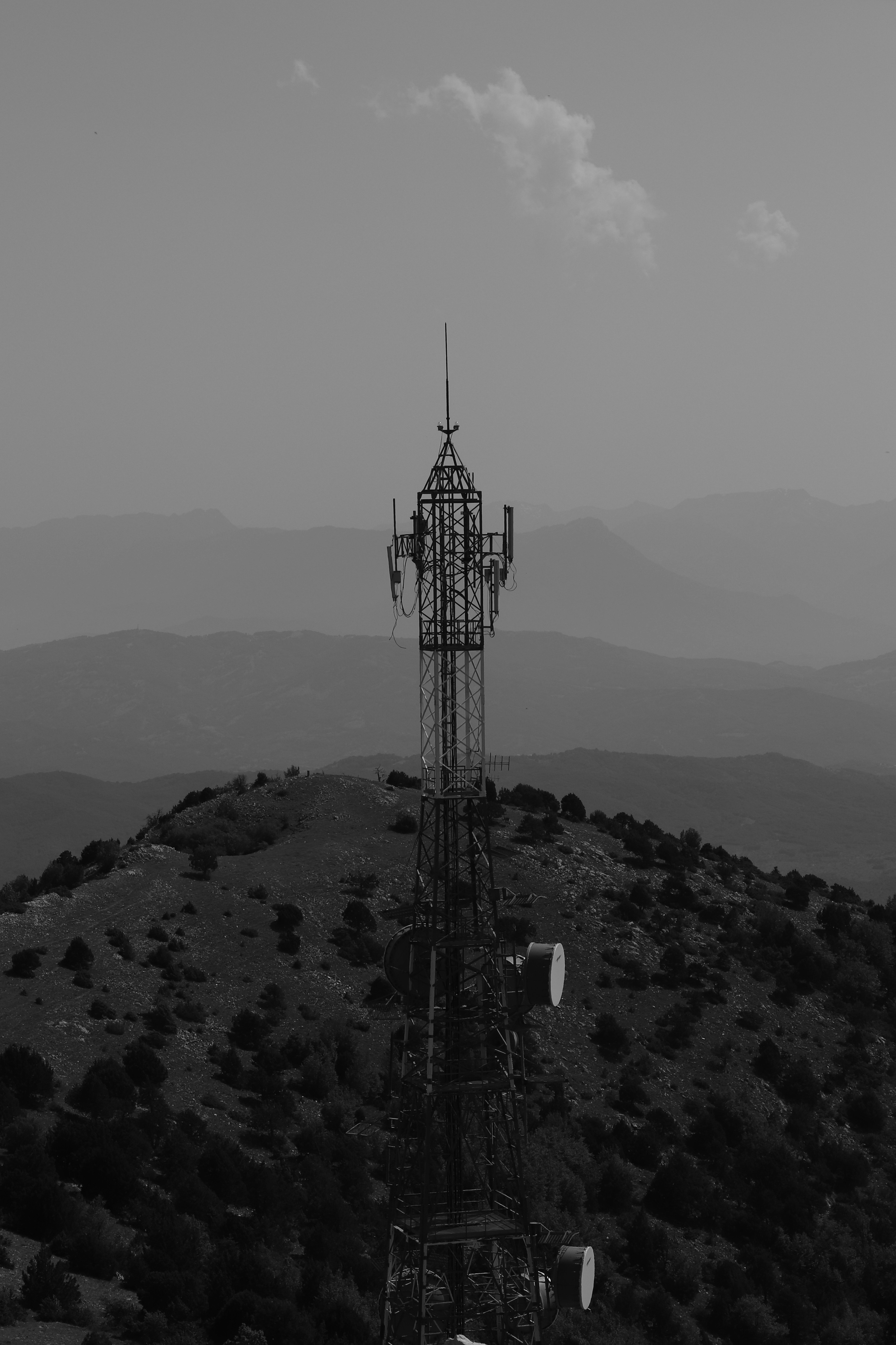 a black and white photo of a cell phone tower