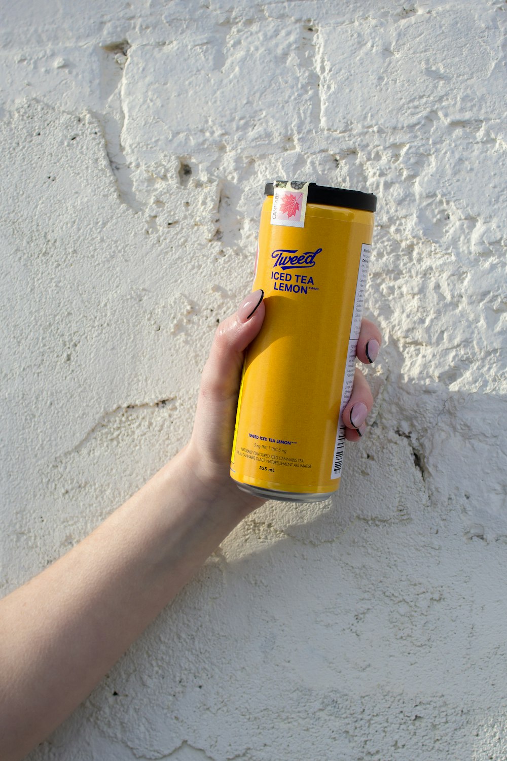a person holding a yellow spray can in their hand