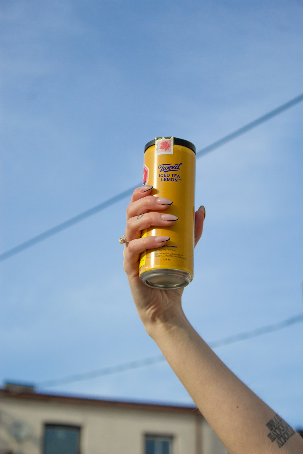 a person holding a can of soda in their hand