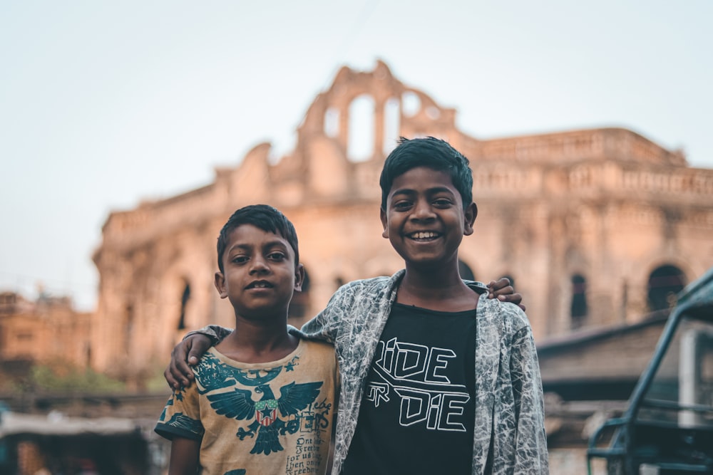 a couple of kids standing next to each other