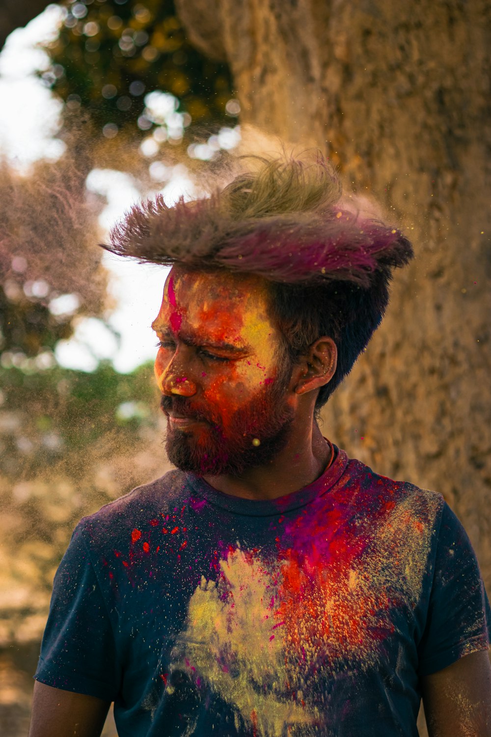 a man with a hat covered in colored powder