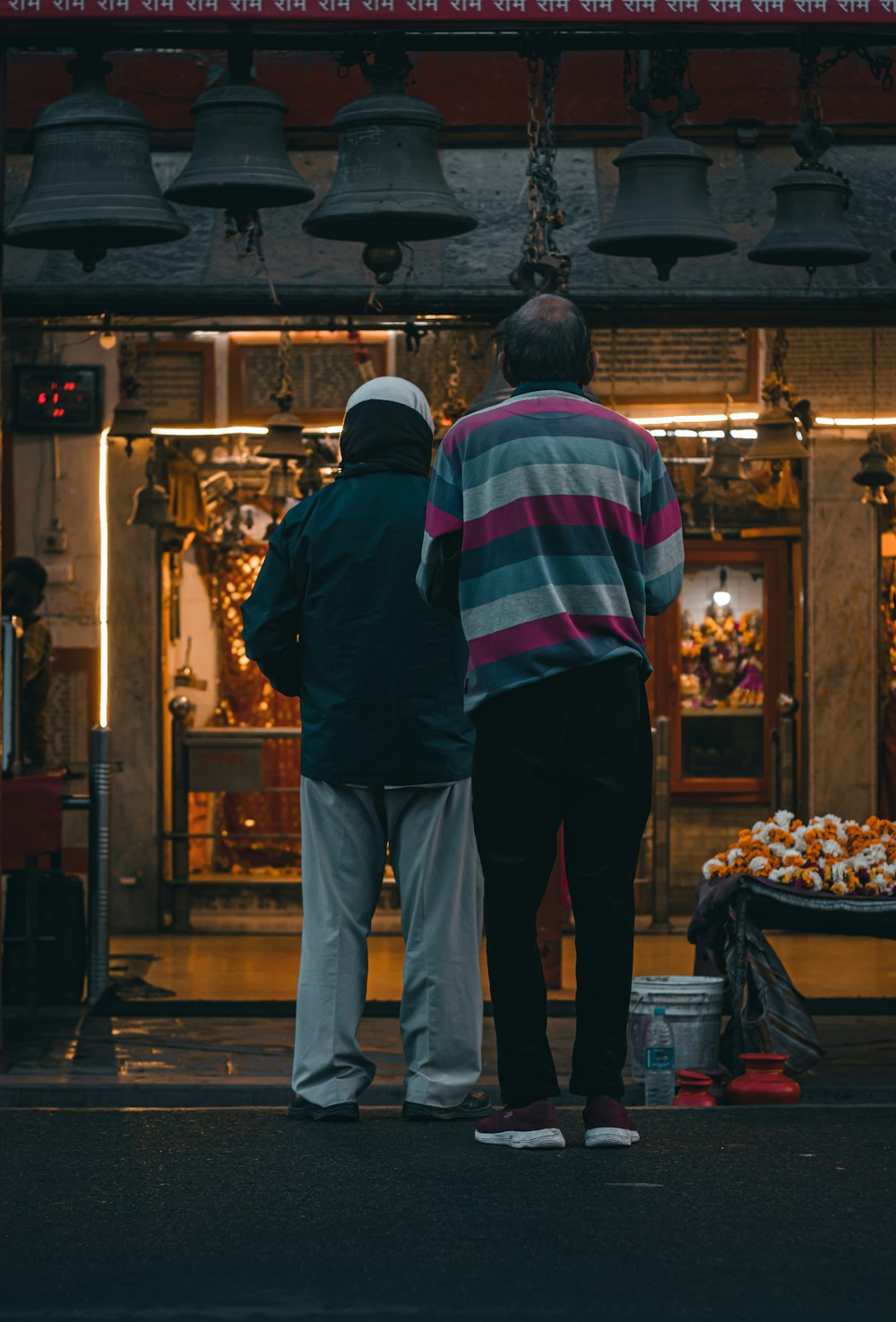 a couple of people standing in front of a store