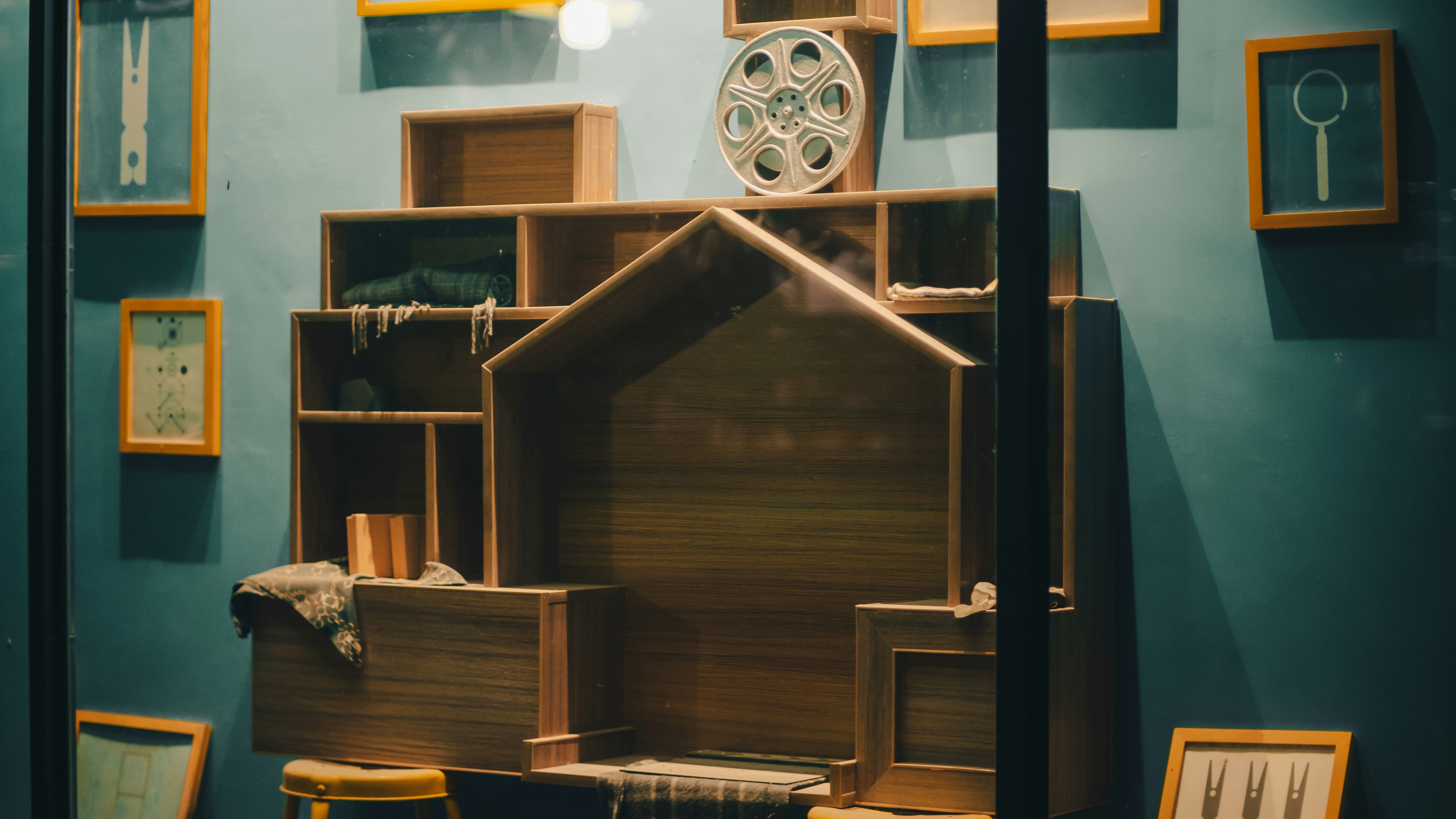 a display case with a wooden house on top of it