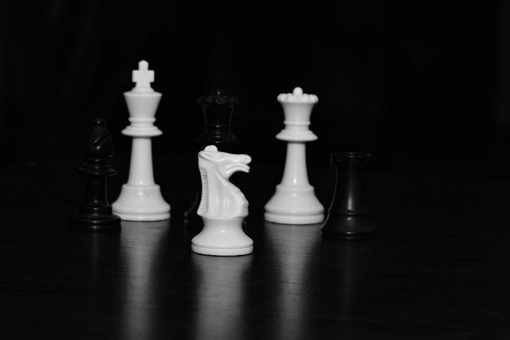 a black and white photo of chess pieces