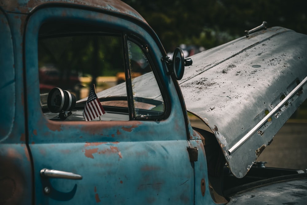 an old truck with an american flag on it