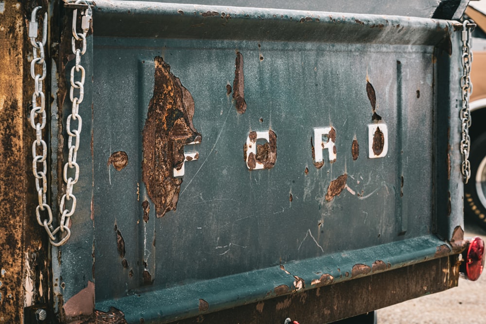 a rusted metal box sitting on the side of a road