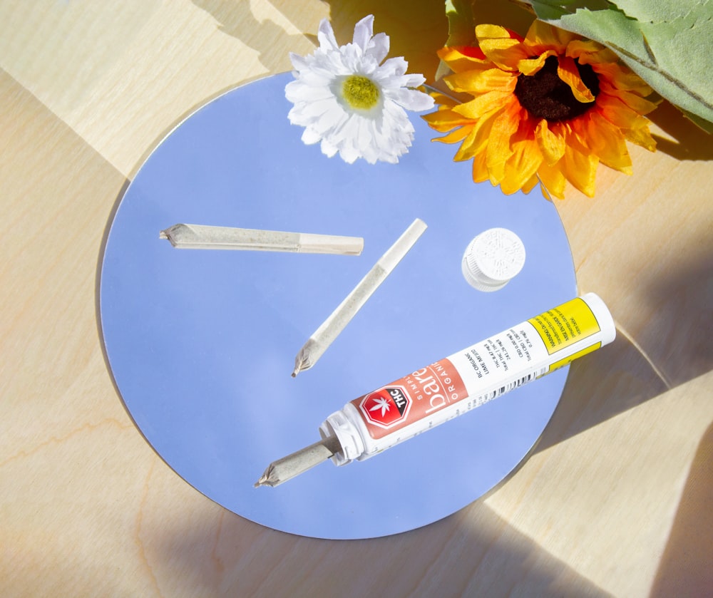 a table with a flower and some glue on it