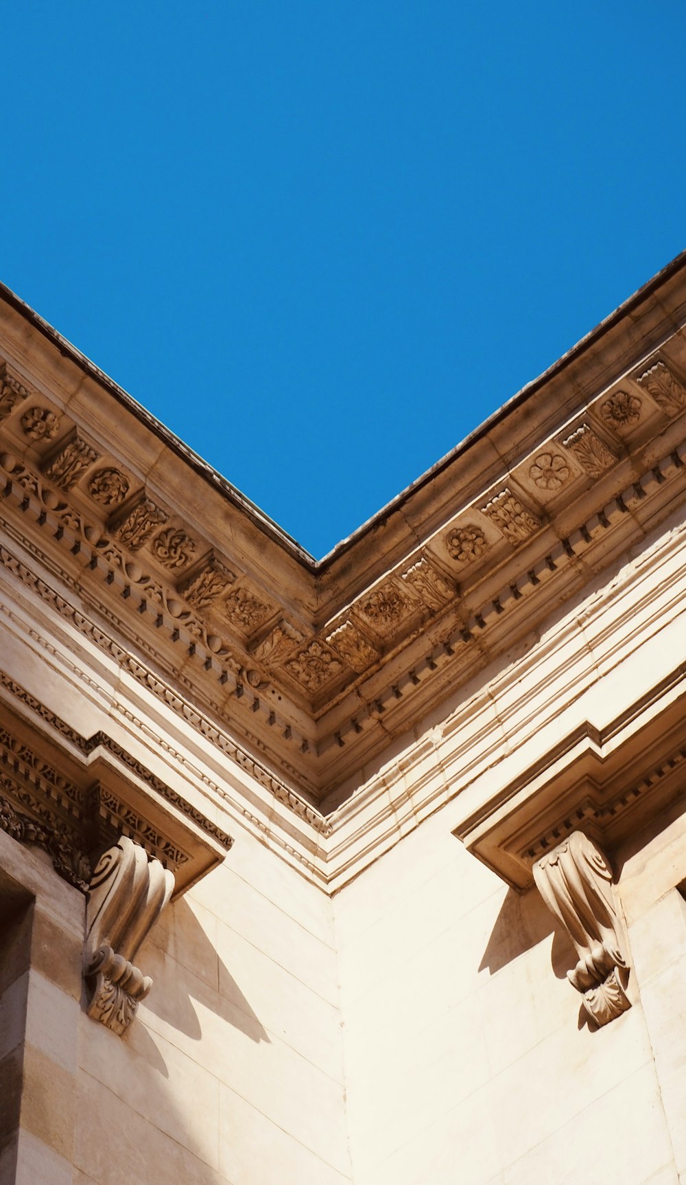 a close up of a building with a blue sky in the background