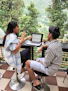 a man and a woman sitting at a table with a laptop