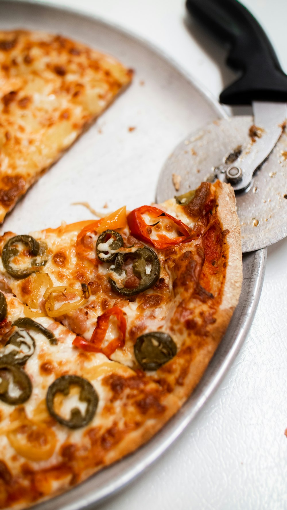 two slices of pizza on a plate with a spatula