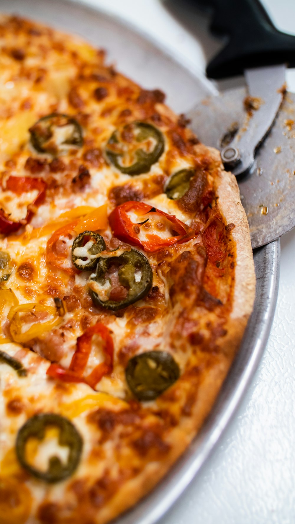 a pizza sitting on top of a pan on top of a table