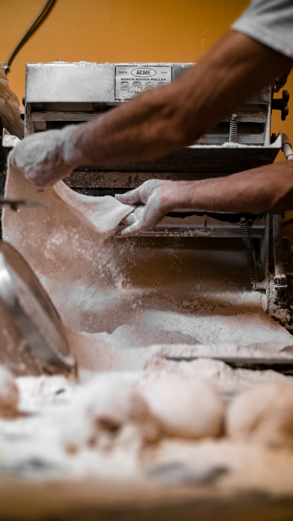 a man is making dough in a kitchen