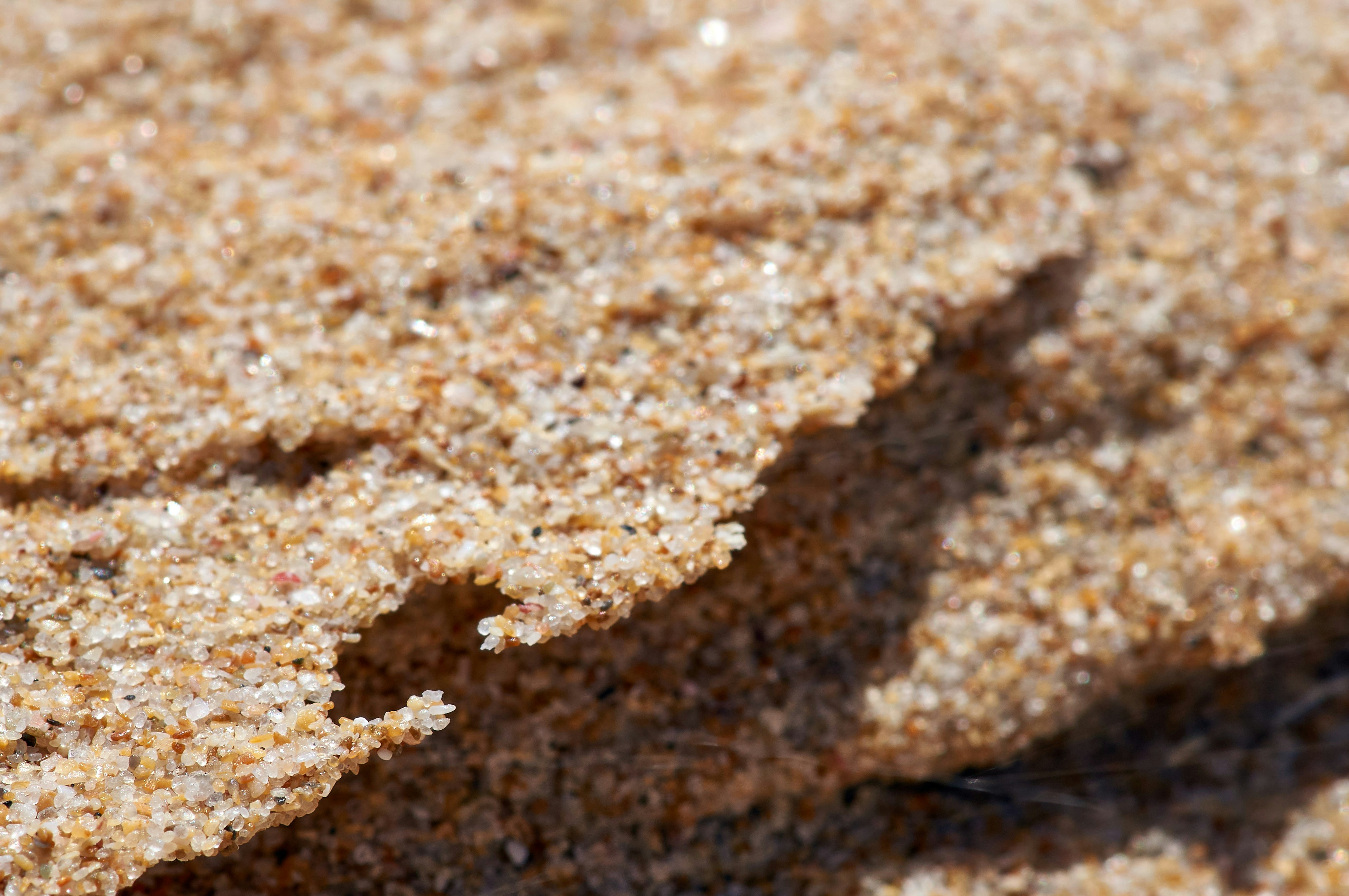 A close up of a sand surface with a small amount of sand photo Free Rock Image on Unsplash