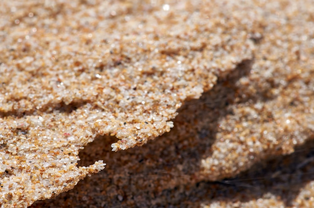 a close up of a sand surface with a small amount of sand