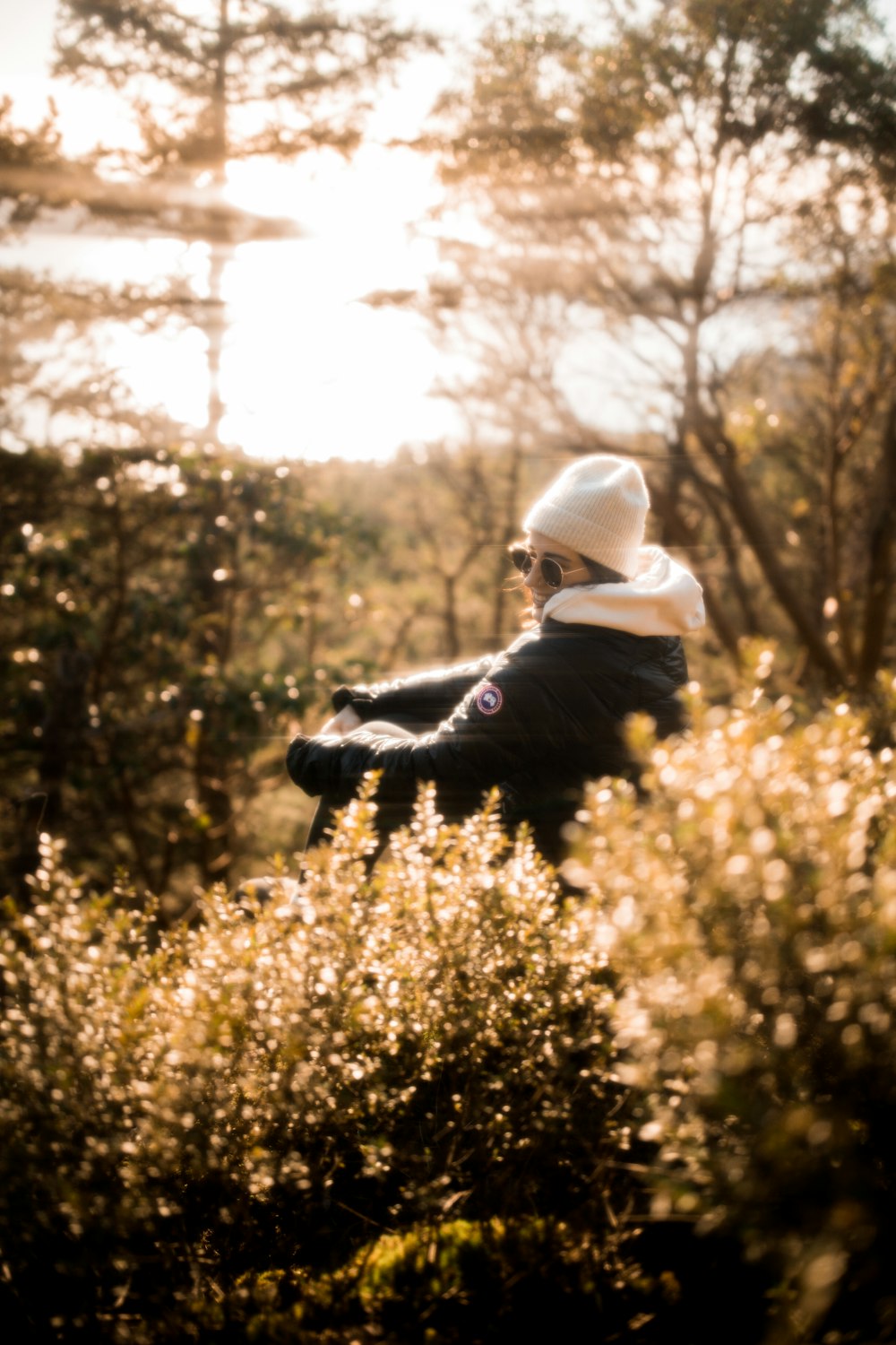 a person sitting on a bench in a field