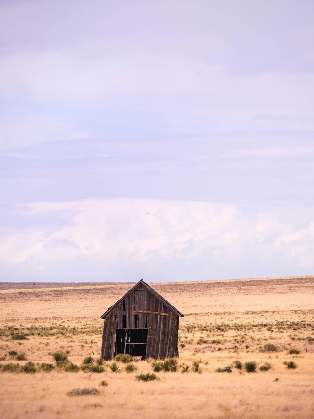 an old barn in the middle of the desert