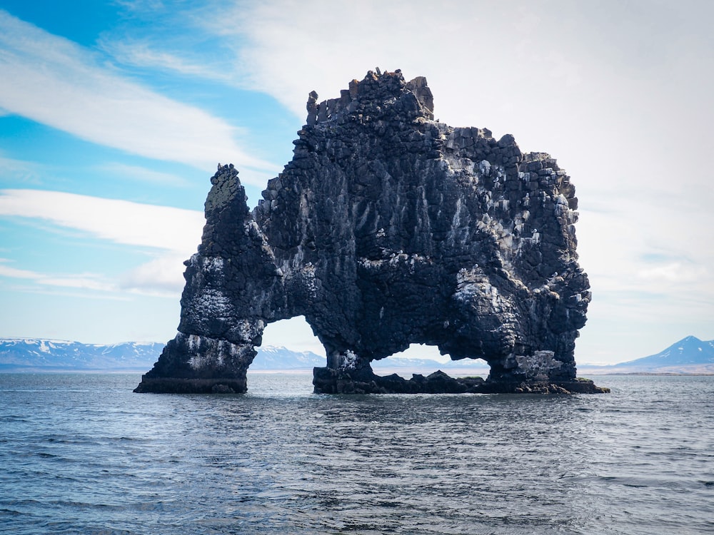 a rock formation in the middle of a body of water