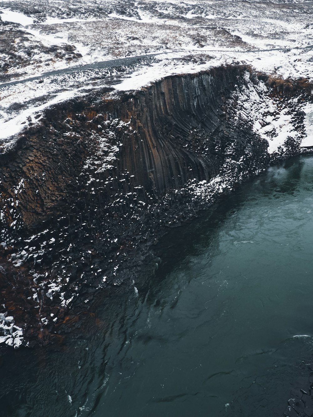 a large body of water surrounded by snow