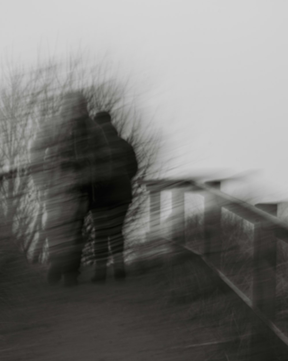 a blurry photo of a person walking down a path