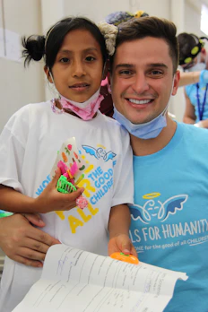 a man holding a little girl in his arms