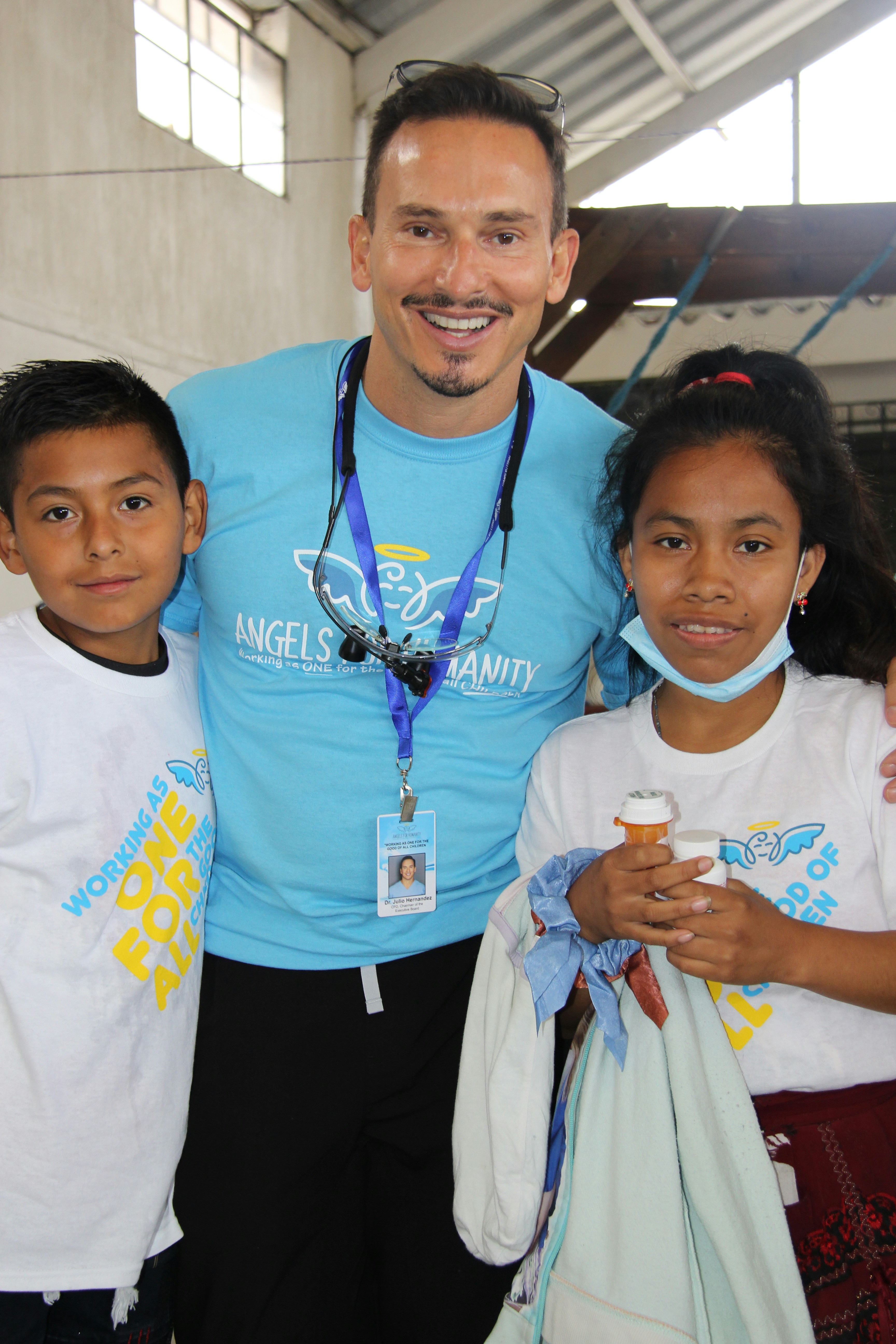 a man standing with two small children