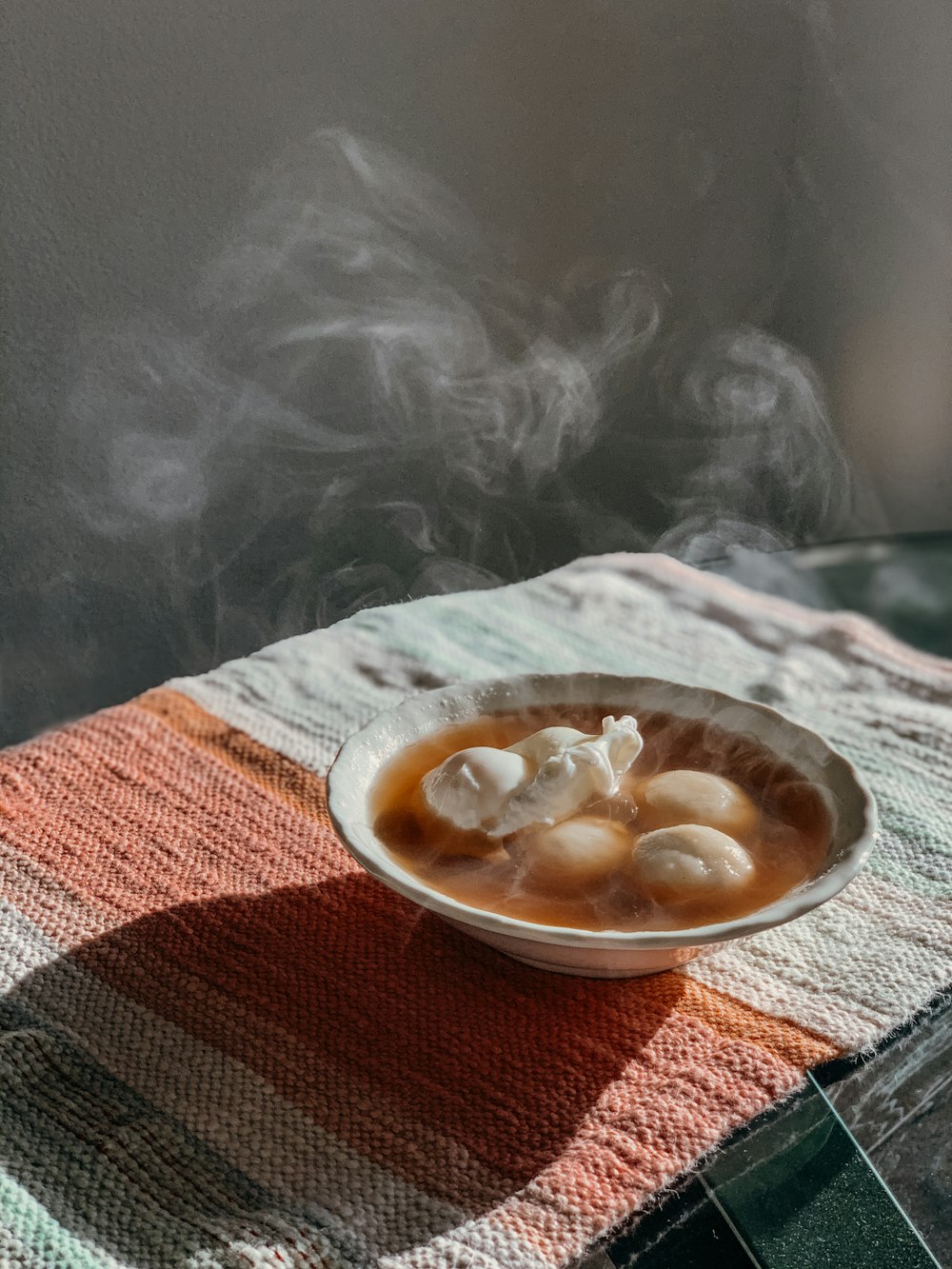 a bowl of food with steam coming out of it