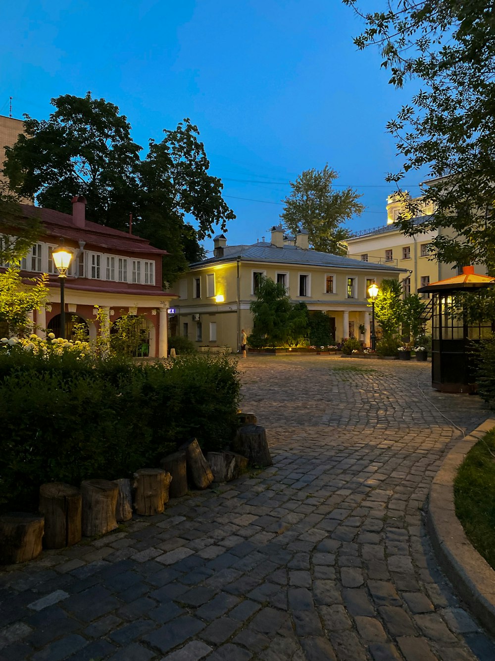 a cobblestone street with a clock tower in the distance