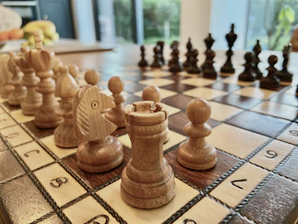 a close up of a chess board with pieces on it