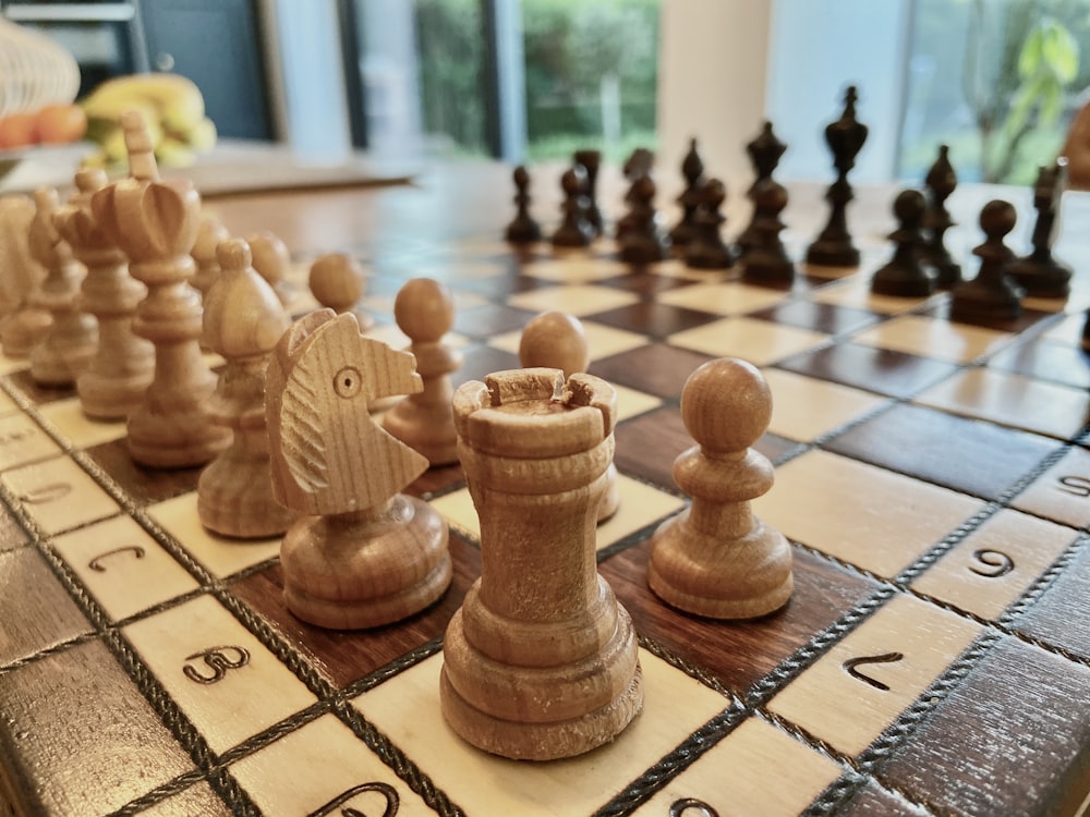 a close up of a chess board with pieces on it