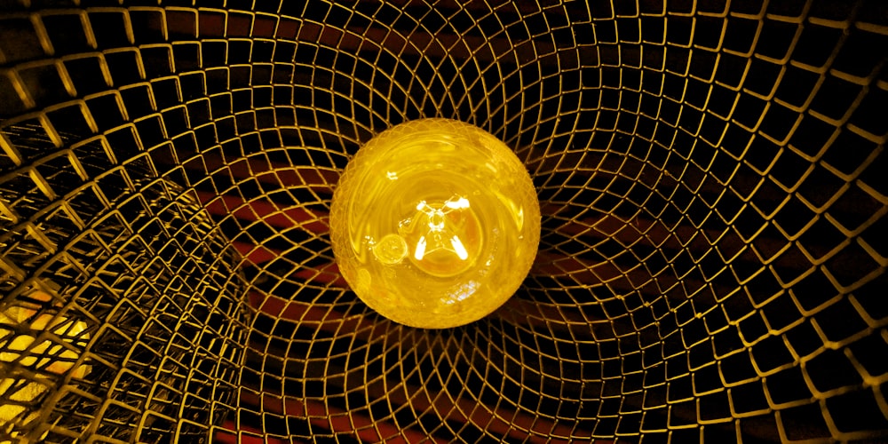 a yellow object sitting inside of a metal cage