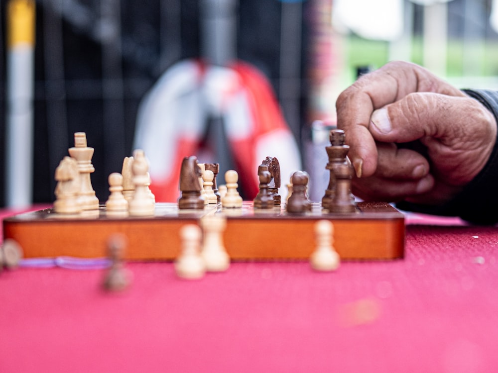 a man playing a game of chess on a table
