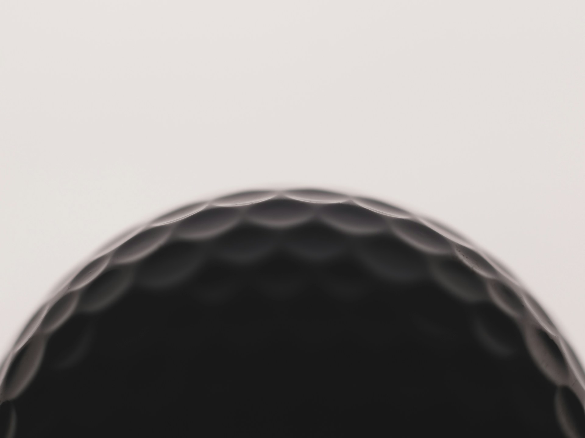 a close up of a black golf ball