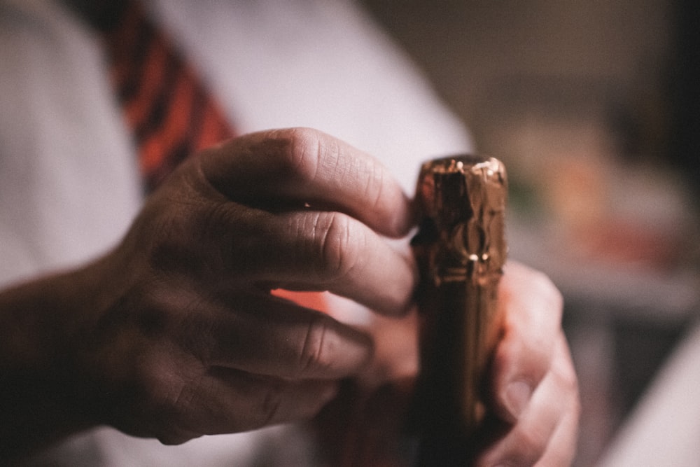 a close up of a person holding a lighter