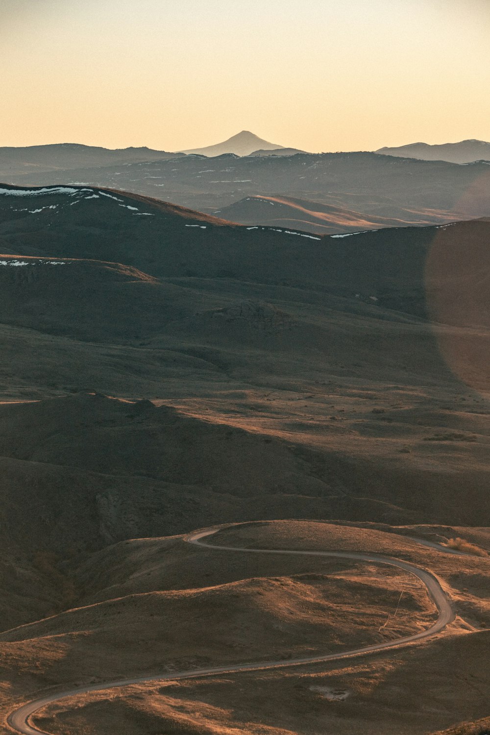 a view of a winding road in the mountains