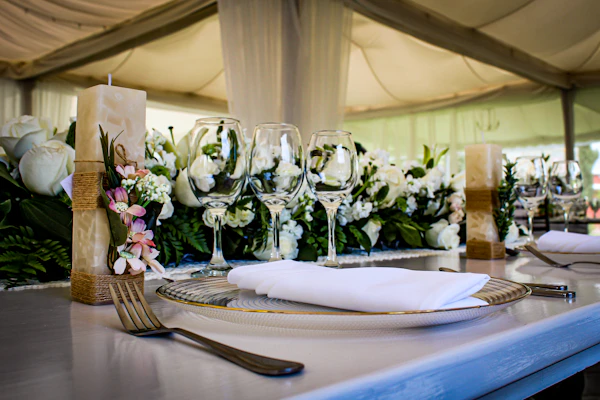 Banquet table styled with florals, candles and linen