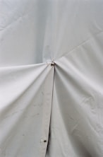 Close-up of a sturdy, waterproof tarpaulin freshly installed over a commercial truck.