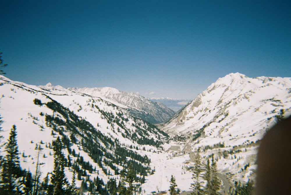 a view of a snowy mountain range from a helicopter