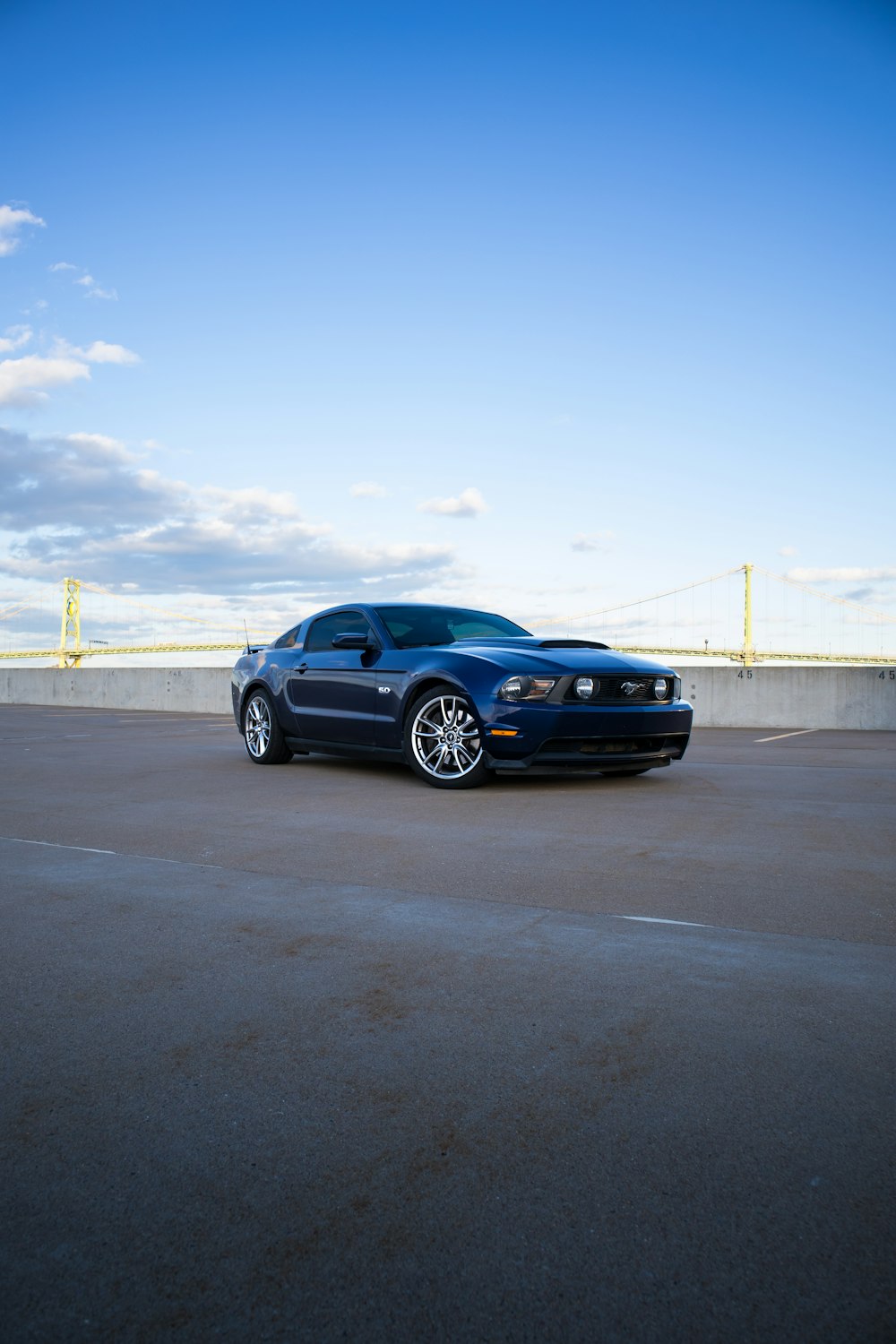 a blue sports car parked in a parking lot