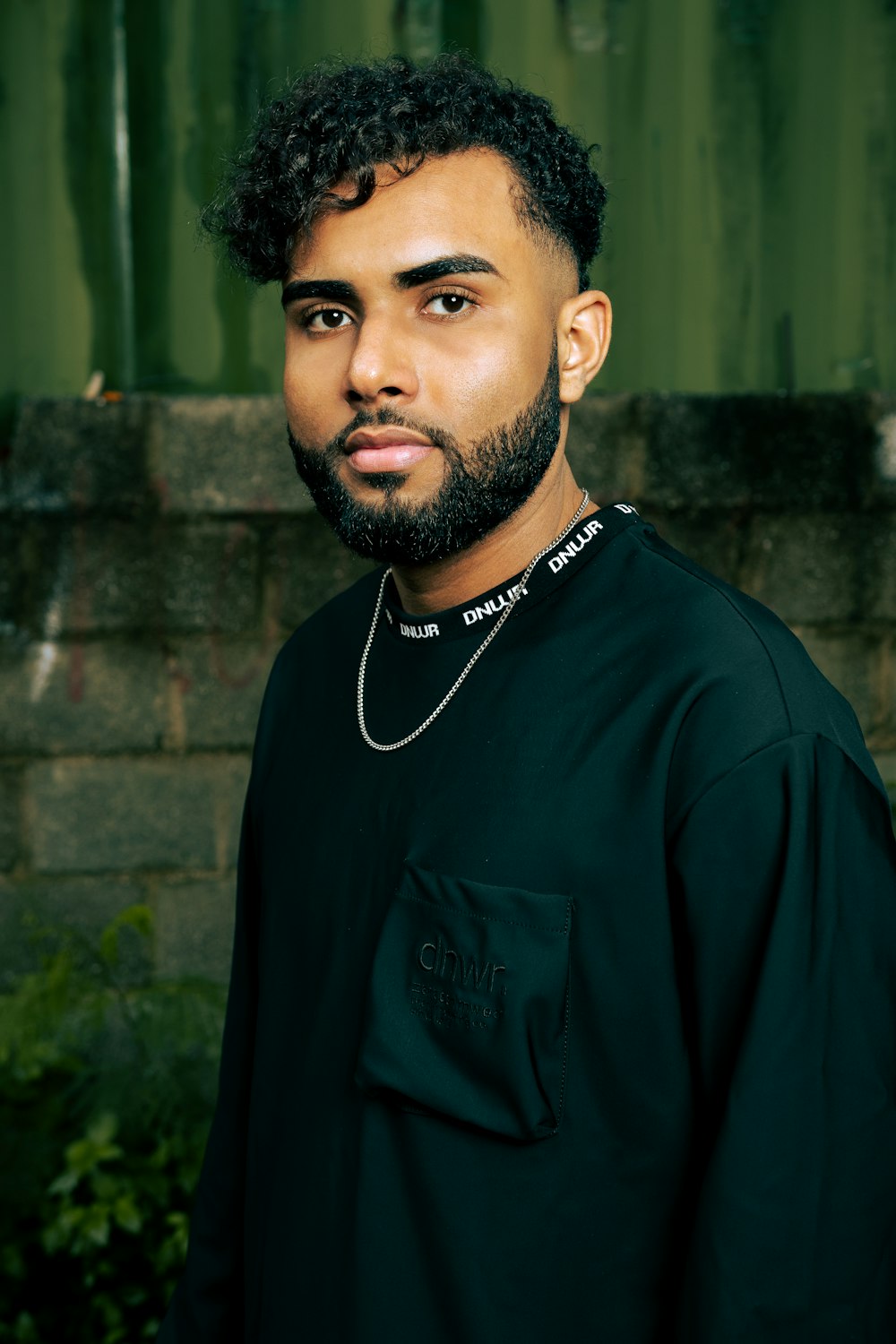 a man with a beard wearing a black shirt