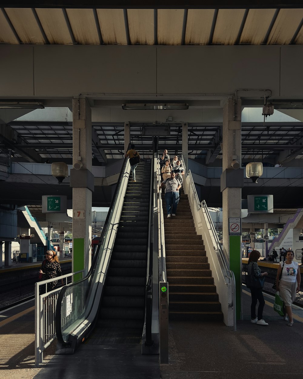 a group of people riding down a set of escalators