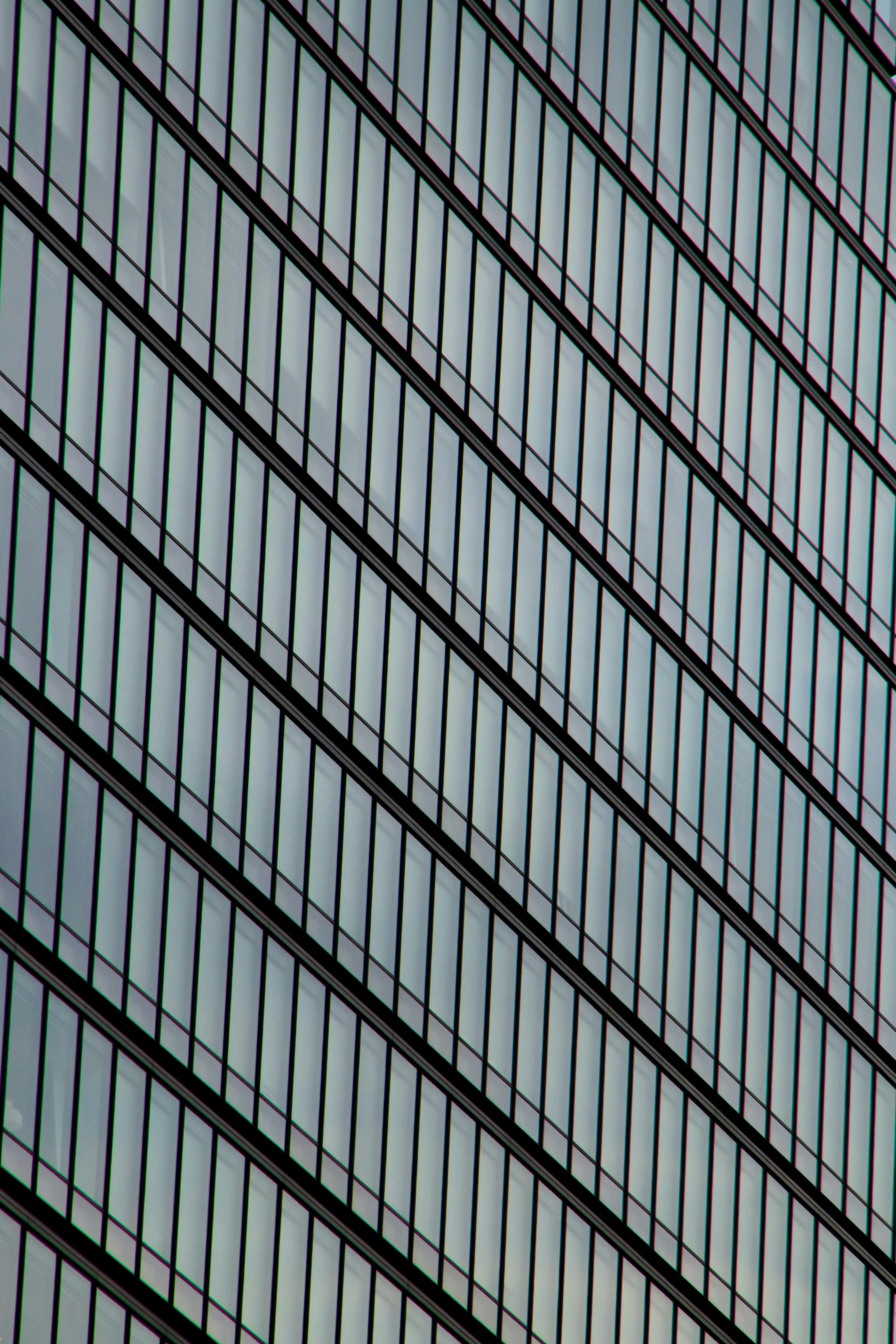 a plane flying in the sky near a building