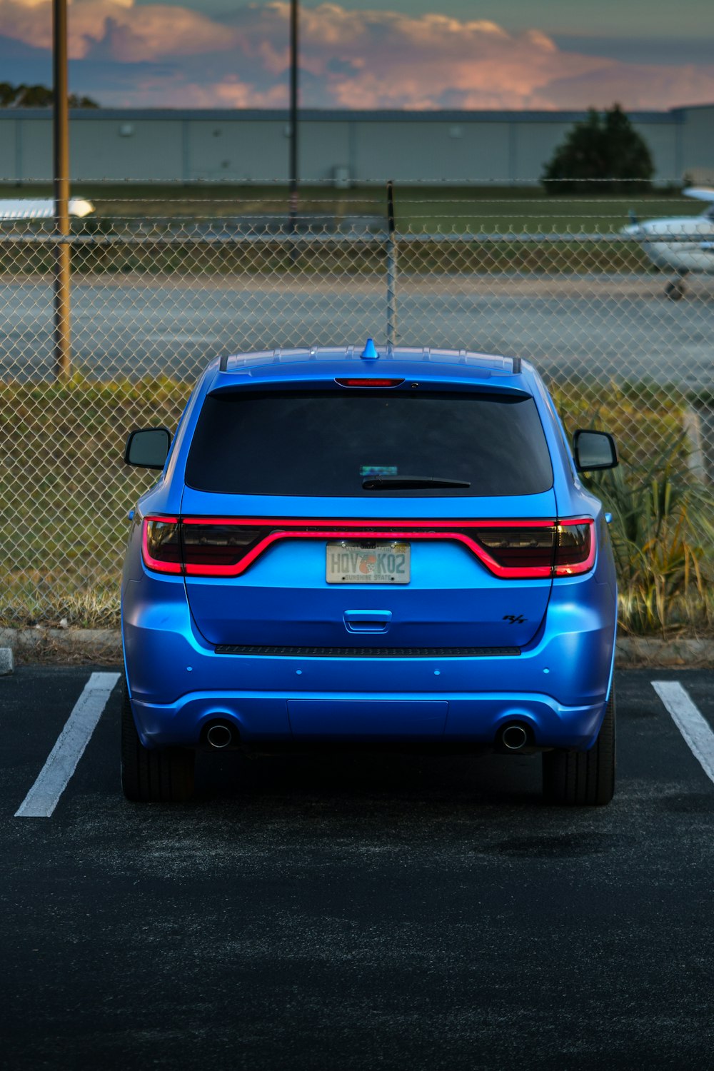 a blue car parked in a parking lot