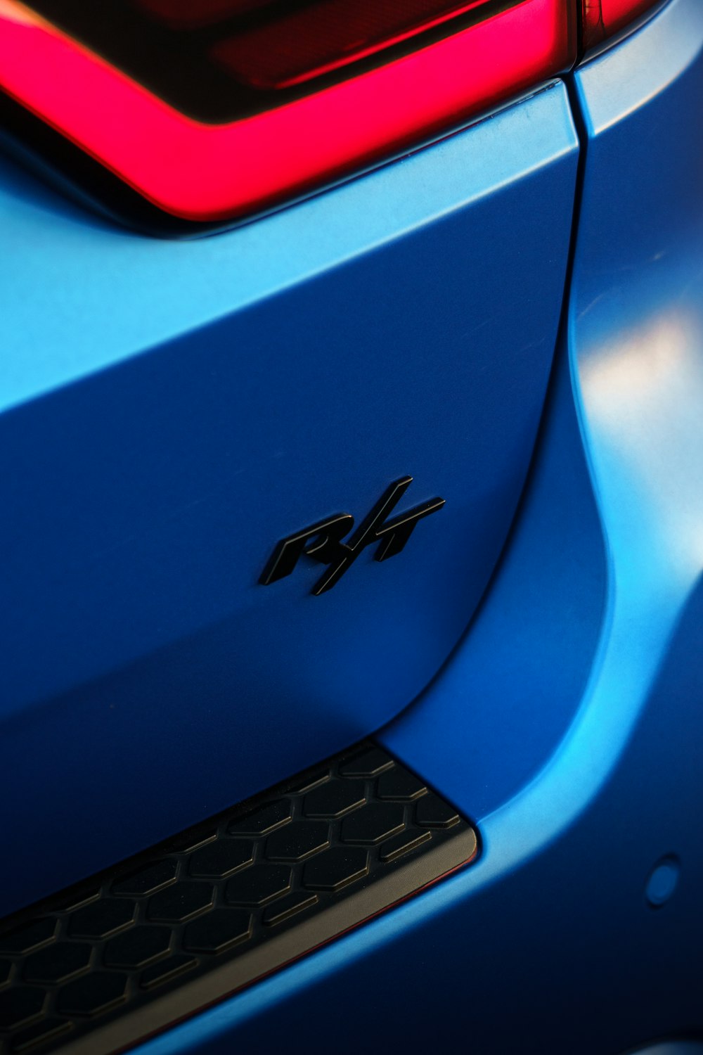 the tail lights of a blue sports car